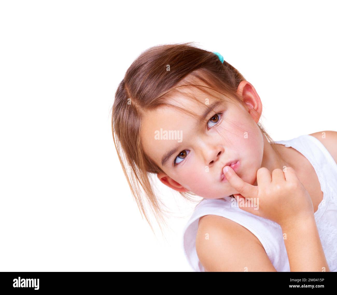 I wonder...A cute little girl looking thoughtful with her finger on her lips. Stock Photo