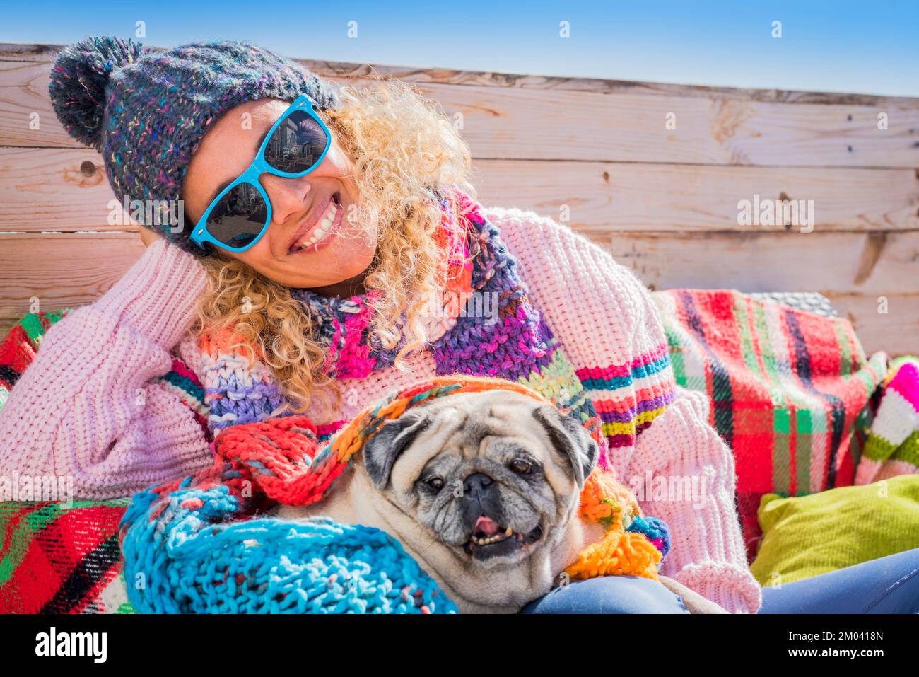 Happy woman smile and look on camera with her adorable pug puppy. Female people and dog best friend owner concept. Winter outdoor leisure activity peo Stock Photo