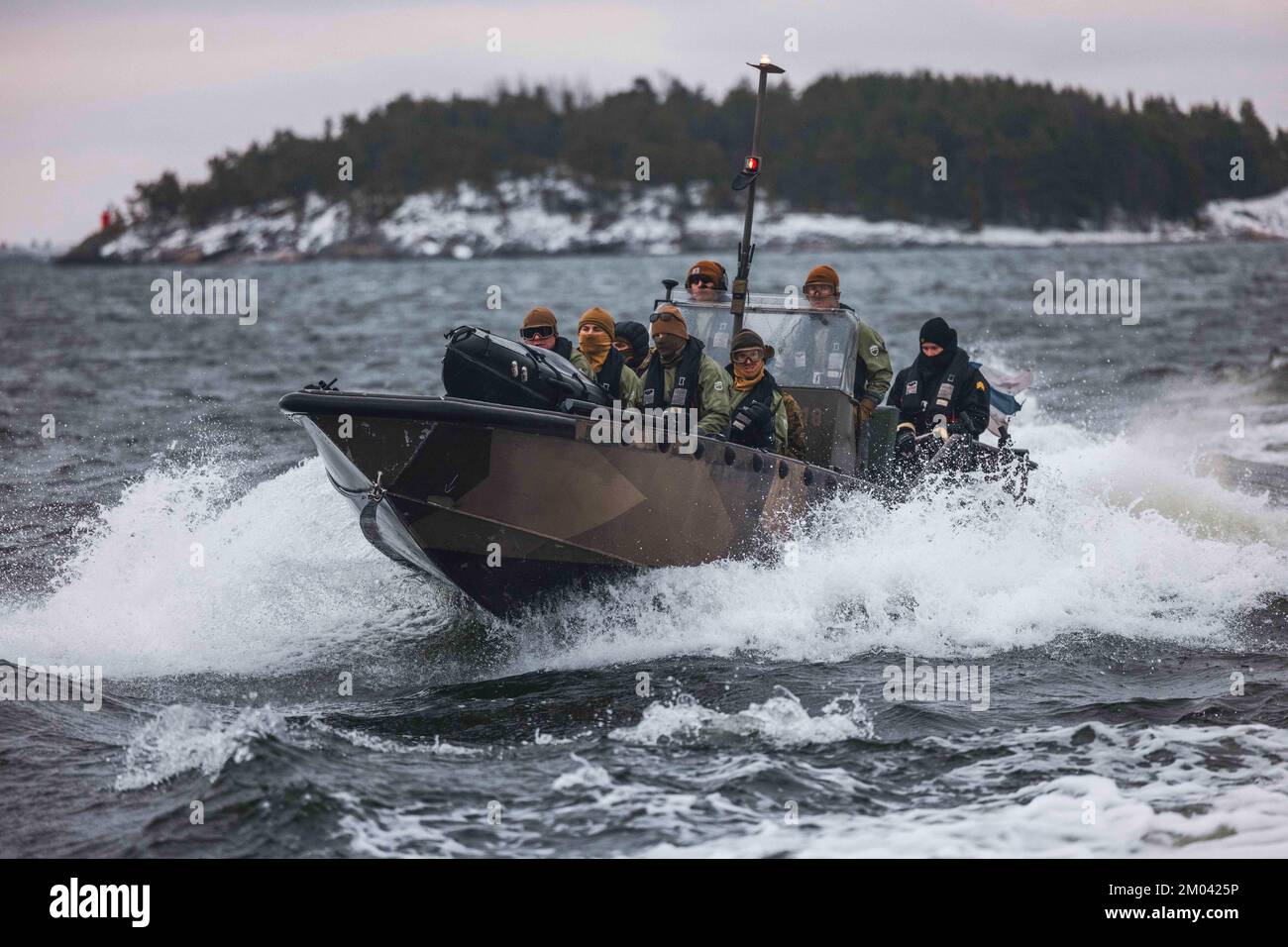 Baltic Sea. 25th Nov, 2022. U.S. Marines with Combat Logistics Battalion 6, Combat Logistics Regiment 2, 2nd Marine Logistics Group, drive a Finnish G-Class landing craft while operating the Amy, an unmanned surface vehicle on the Baltic Sea, off the coast of Finland Nov. 25, 2022. Task Force Red Cloud, headquartered by elements of CLB-6, is deployed to Finland in support of Exercises SYD 2022 and Freezing Winds 2022 to enhance U.S. and Finnish select interdependence in the maritime domain; solidify bilateral maritime maneuver within the Finnish littoral environment; and foster strong rel Stock Photo