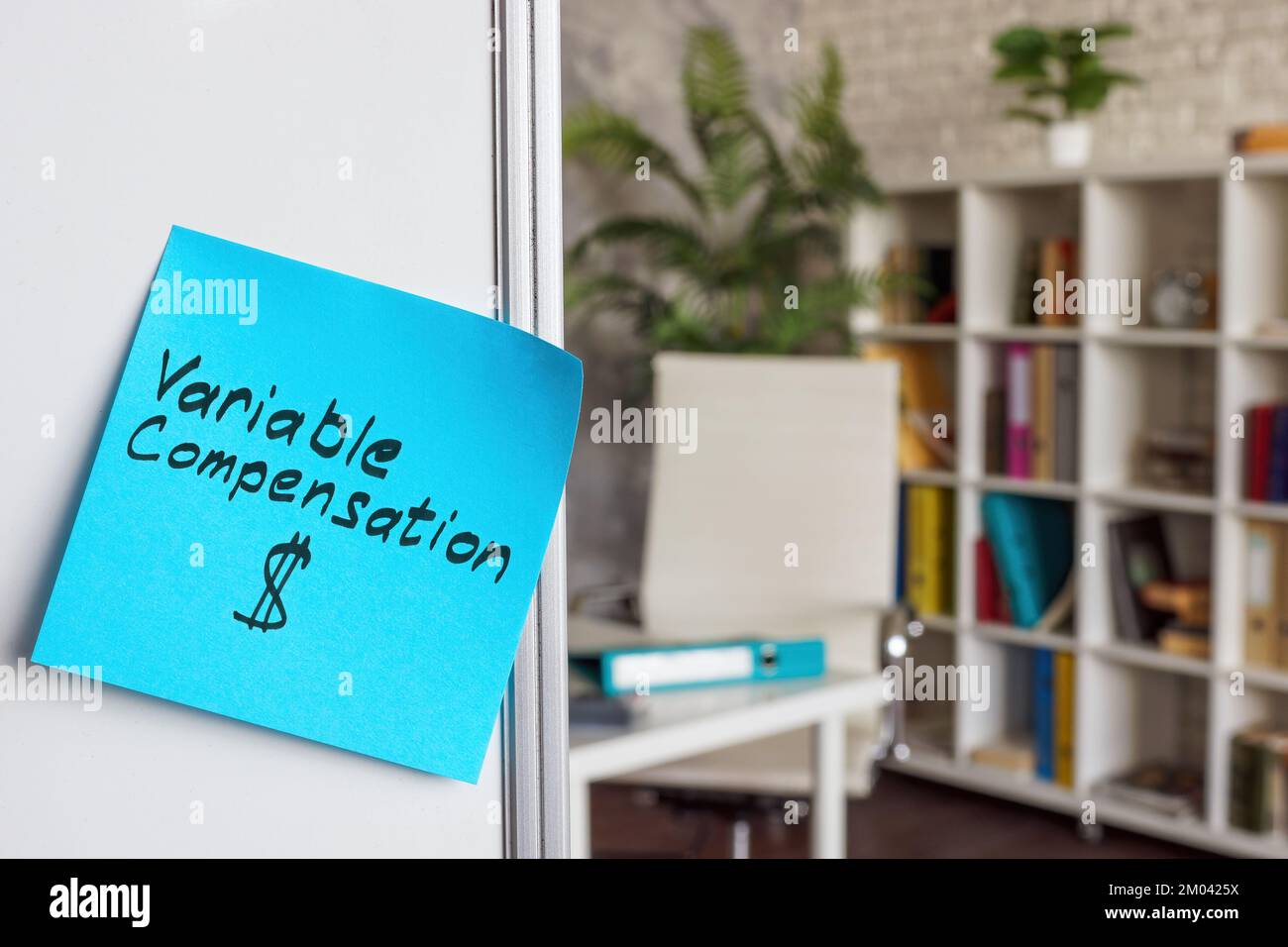 Variable compensation written on a sticker. Whiteboard in the office. Stock Photo