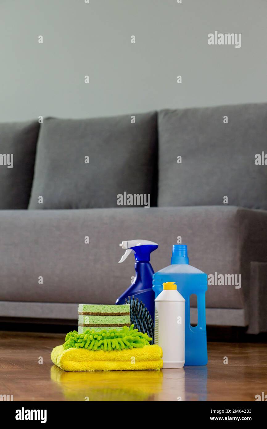 Household cleaning products and rags on floor. Chemical liquids for