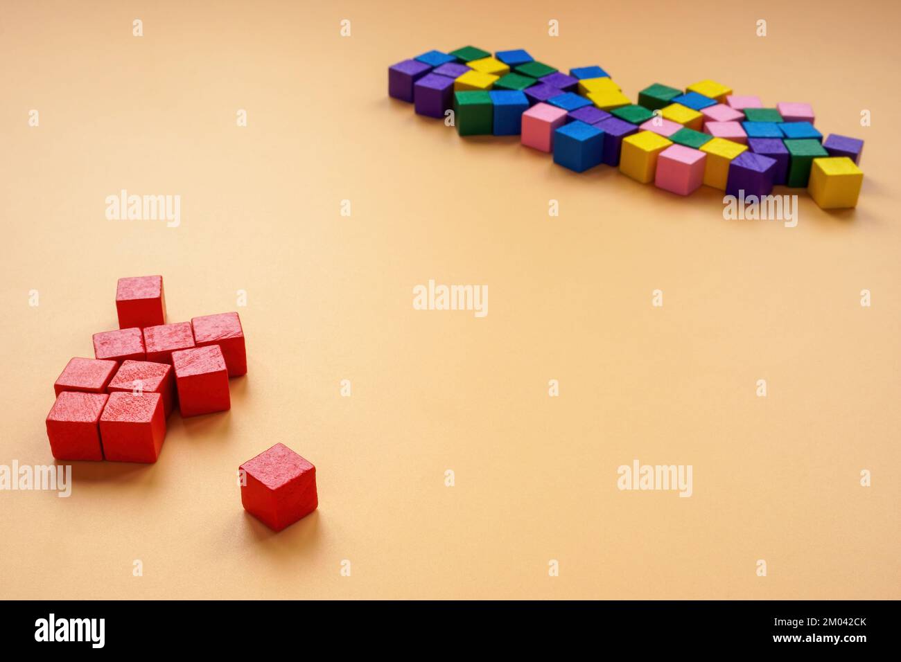 Affinity bias concept. Red cubes lie separately from other colors. Stock Photo