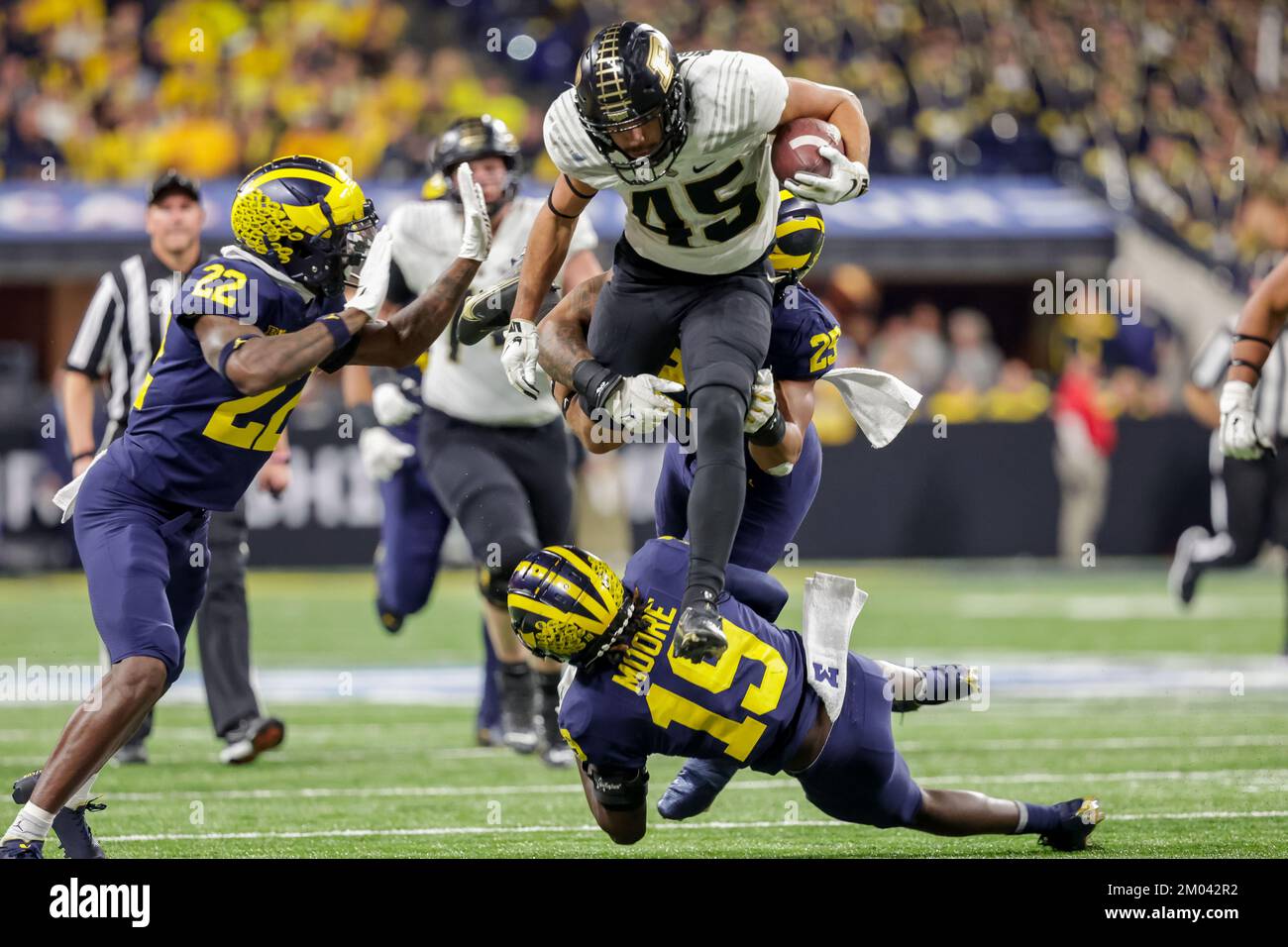 Indianapolis, Indiana, USA. 3rd Dec, 2022. Purdue Boilermakers running back Devin Mockobee (45) jumps over the tackle by Michigan Wolverines defensive back Rod Moore (19) during the game between the Purdue Boilermakers and the Michigan Wolverines in the Big Ten Championship at Lucas Oil Stadium, Indianapolis, Indiana. (Credit Image: © Scott Stuart/ZUMA Press Wire) Stock Photo