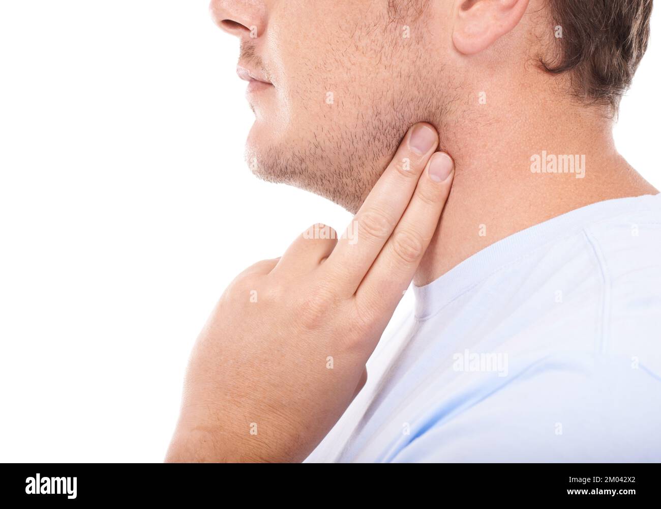 Checking his carotid pulse. Young man taking his heart rate against a