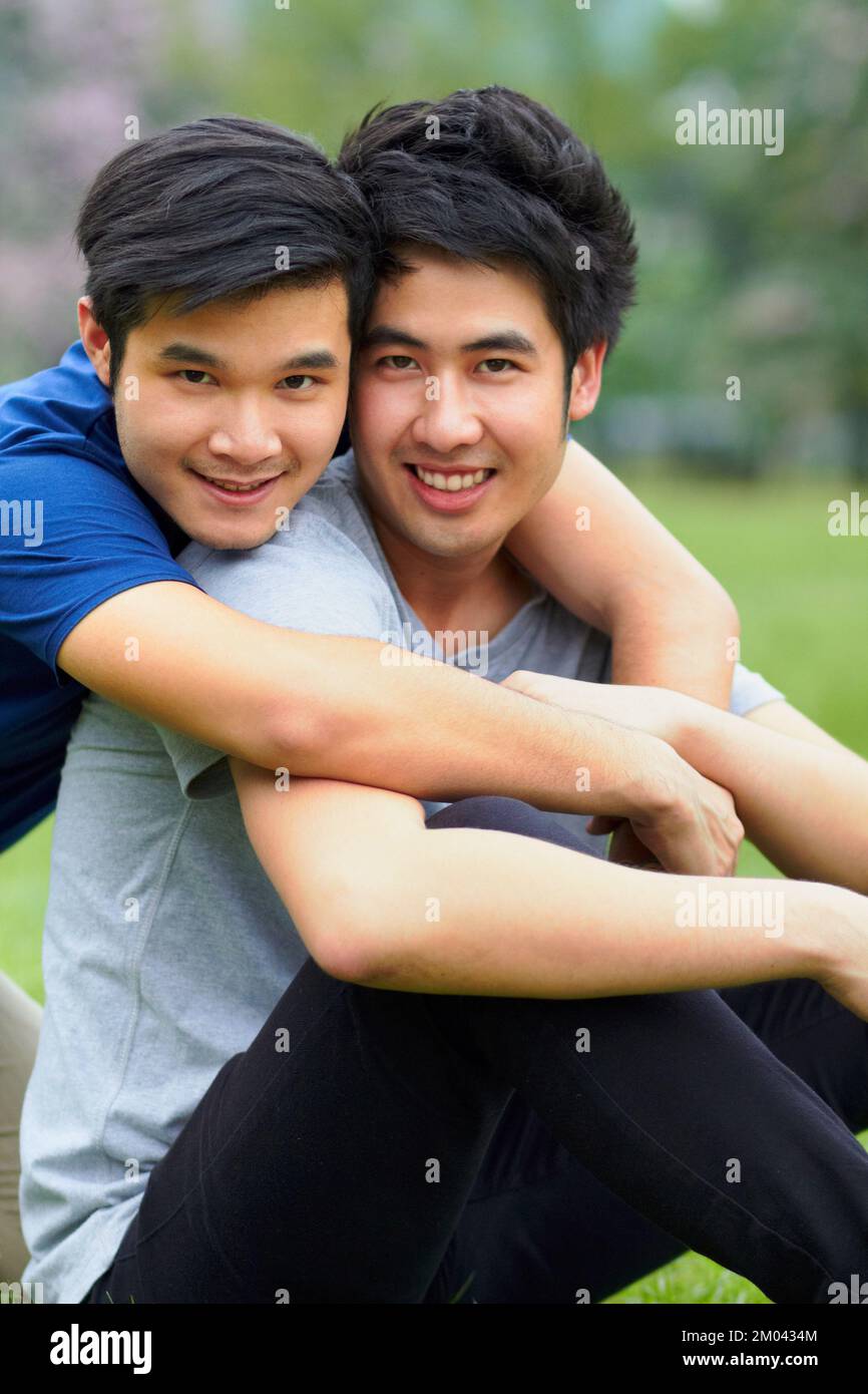 Enjoying a day together. Portrait of an affectionate young gay couple spending time together outdoors. Stock Photo