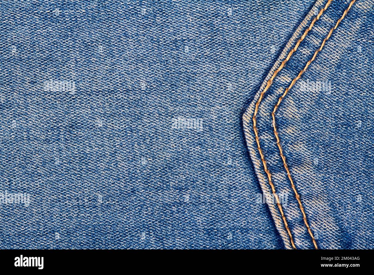 Premium Photo  Part of a blue denim jeans background pocket with damage  and seams with orange thread stitches