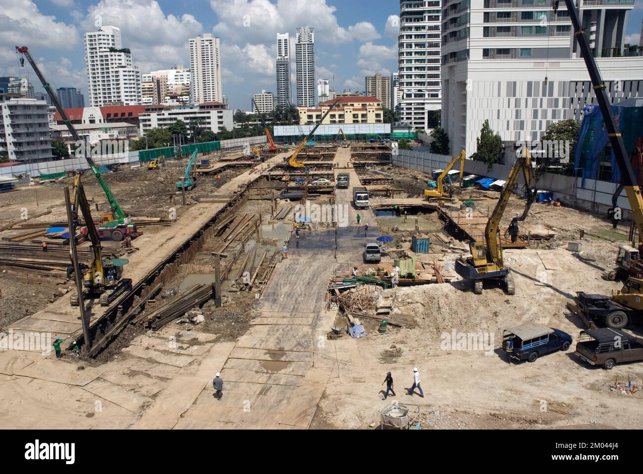 Workers work at the construction site and machines are laying the ...