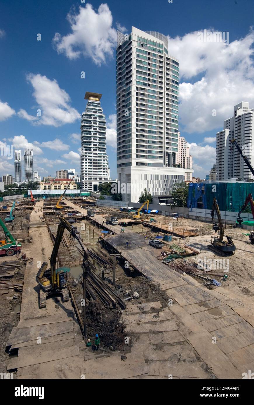Workers work at the construction site and machines are laying the ...