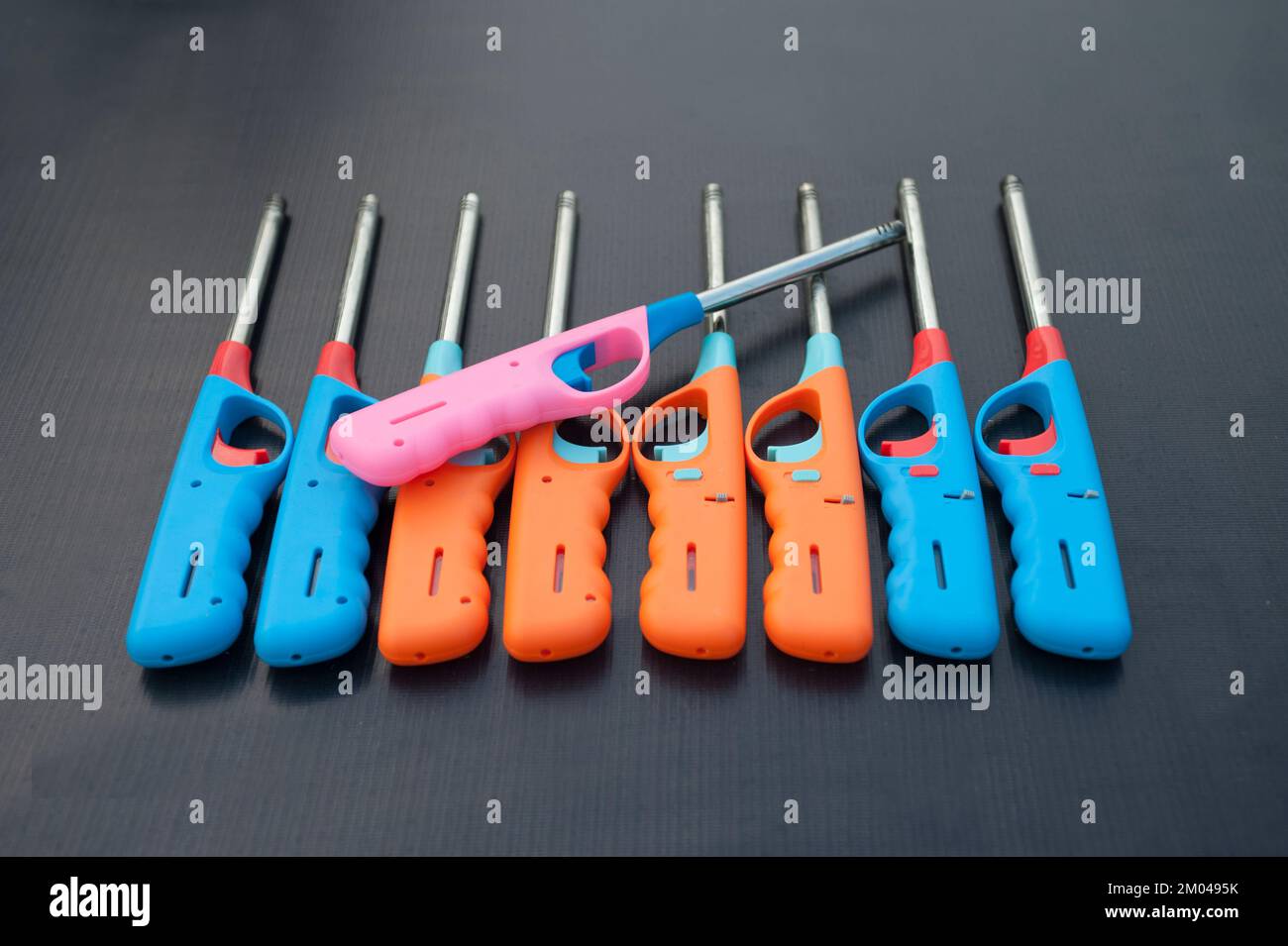 Group of colorful Gas lighter gun for gasstove on a black background
