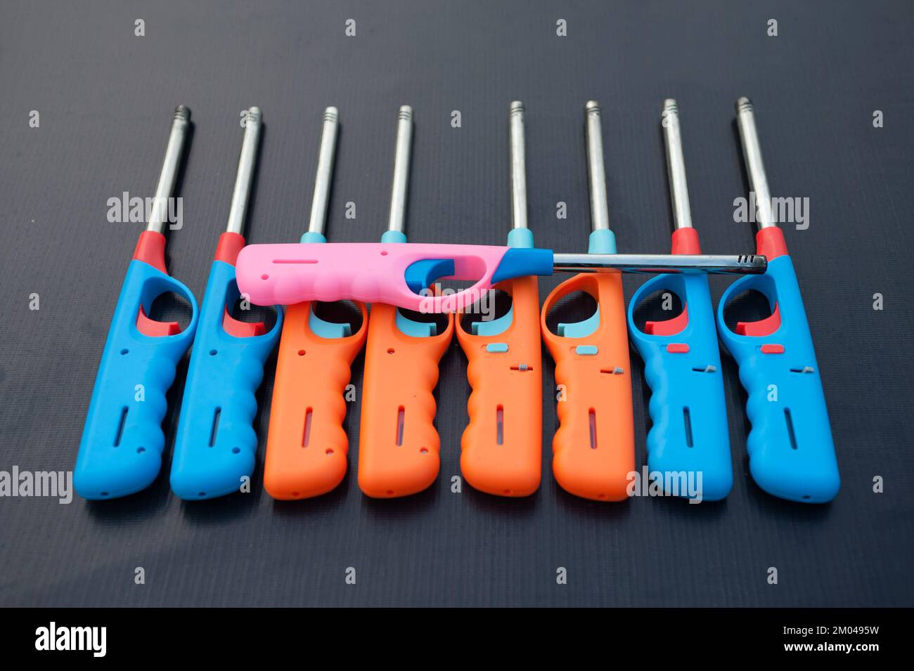 Group of colorful Gas lighter gun for gasstove on a black background