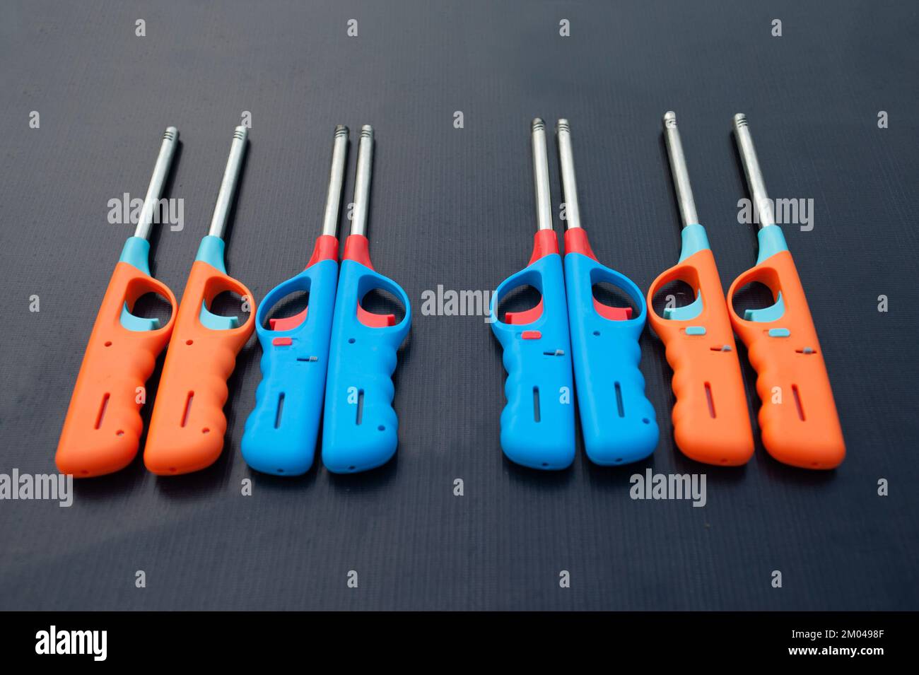 Group of colorful Gas lighter gun for gasstove on a black background