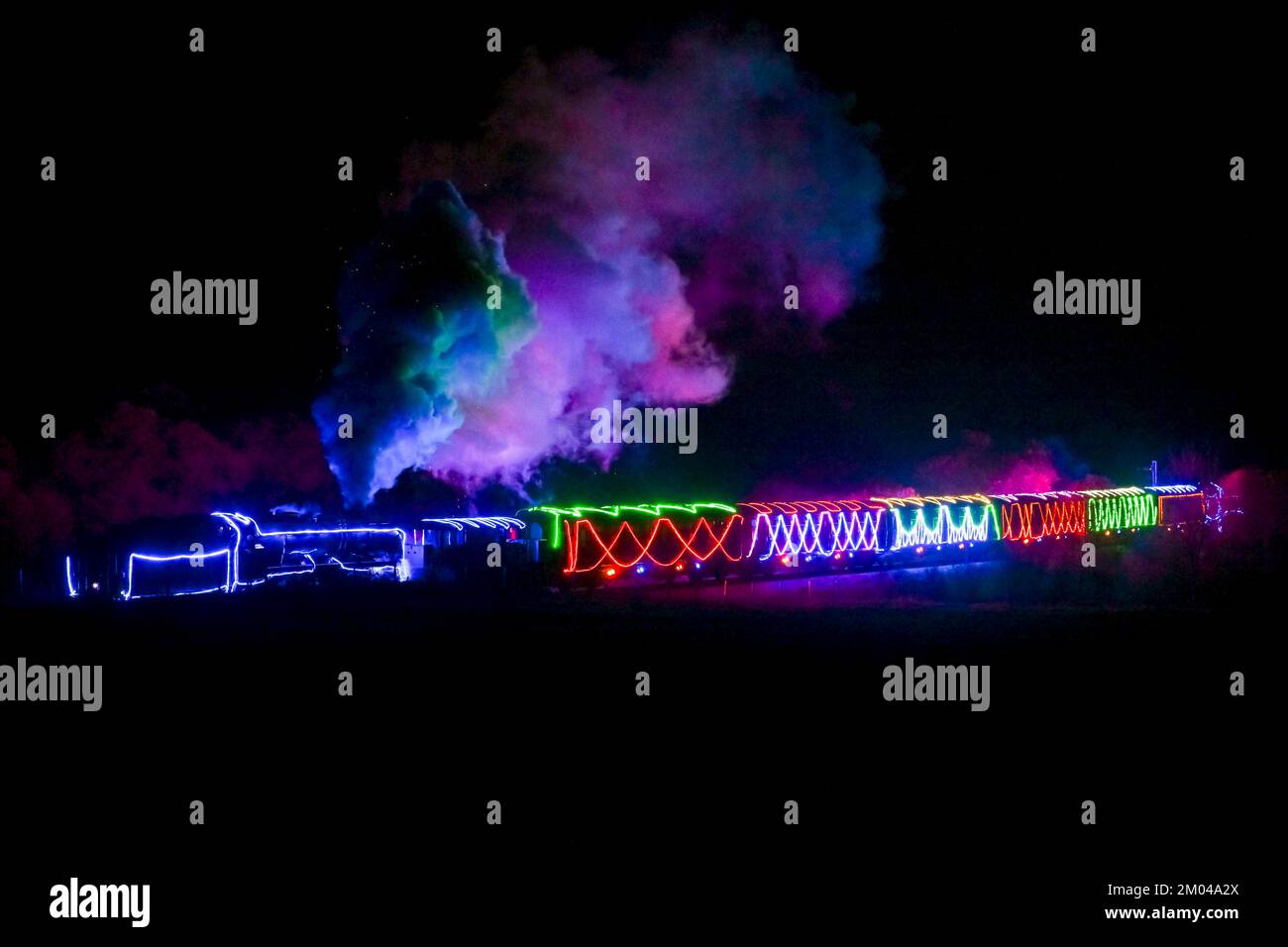 Corfe Castle, Dorset, UK. 3rd December 2022. A steam train lit with