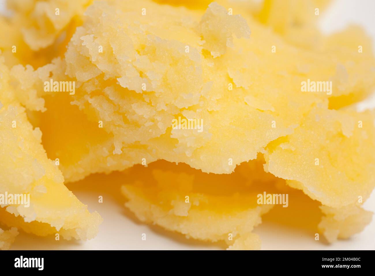 Homemade melted ghee clarified butter close up macro food background
