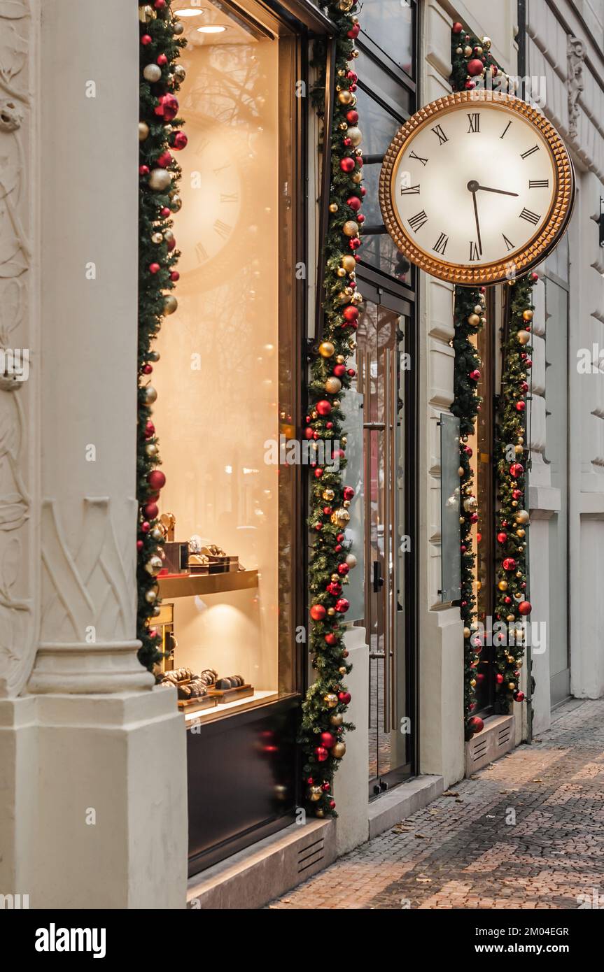 Clock shop with Christmas decor and illumination in Prague. Stock Photo