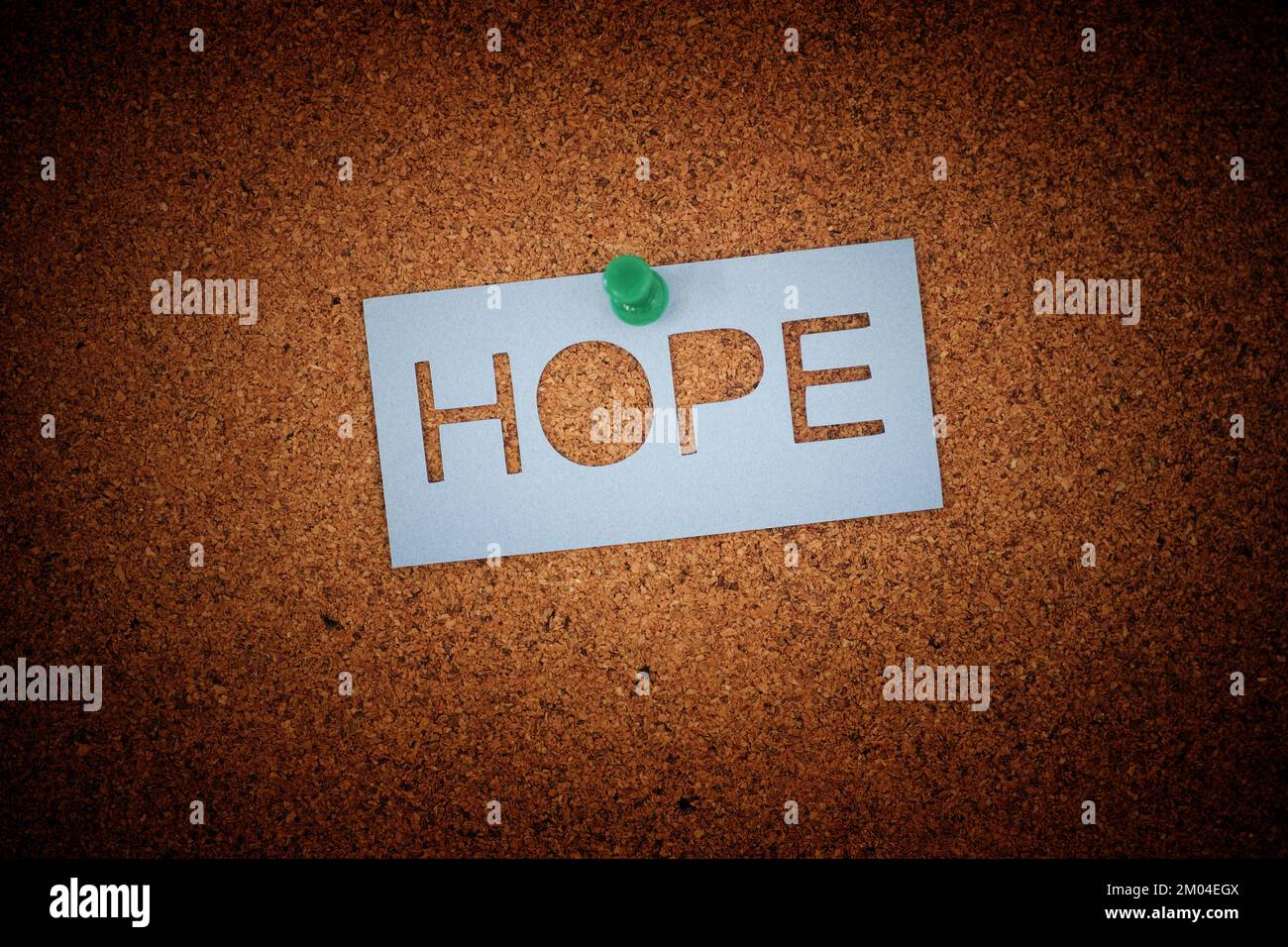 The word Hope pinned to a cork board. Close up. Stock Photo