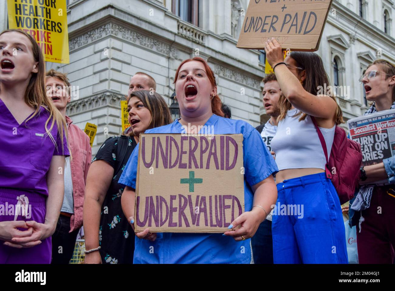 London, UK. 25th July, 2022. A protester holds an 'Underpaid and undervalued' placard during the demonstration outside Downing Street. Hundreds of doctors, nurses, and supporters marched to Downing Street demanding fair pay. (Credit Image: © Vuk Valcic/SOPA Images via ZUMA Press Wire) Stock Photo