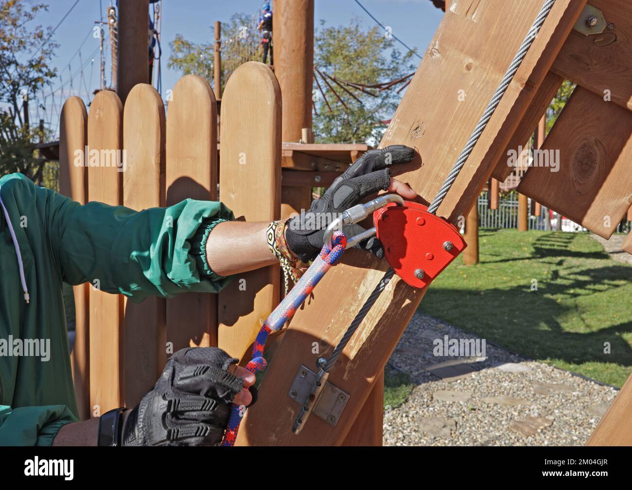 instructor explains how to use belay carabiners with ropes. On the