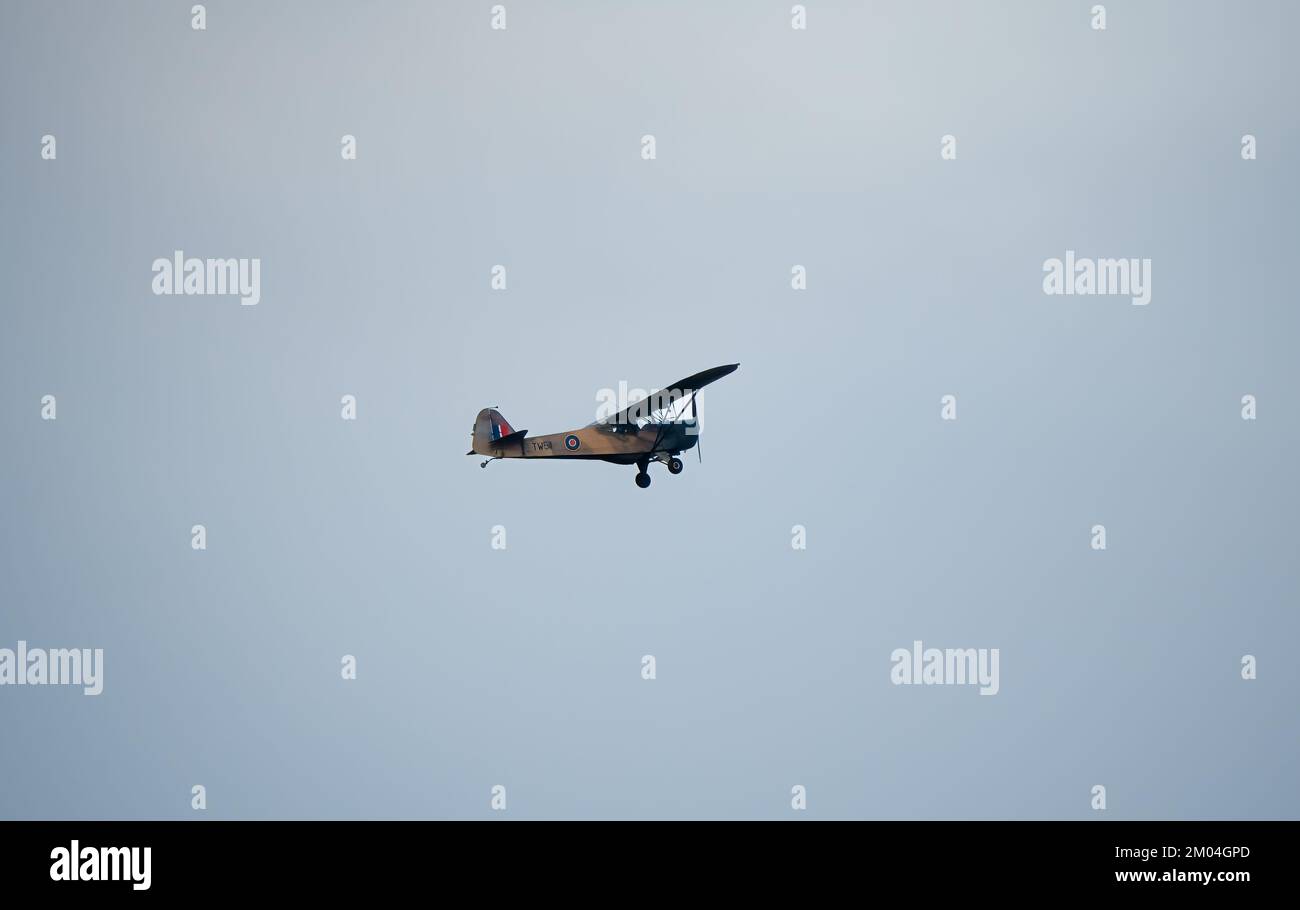 TW511 Auster 5 G-APAF vintage army liaison and observation aircraft ascending in a blue grey autumn sky, Wiltshire UK Stock Photo