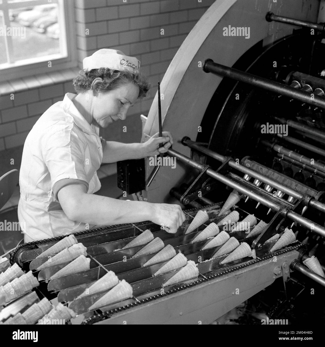 Ice Cream in the 1960s. Interior of a ice cream factory where a woman i