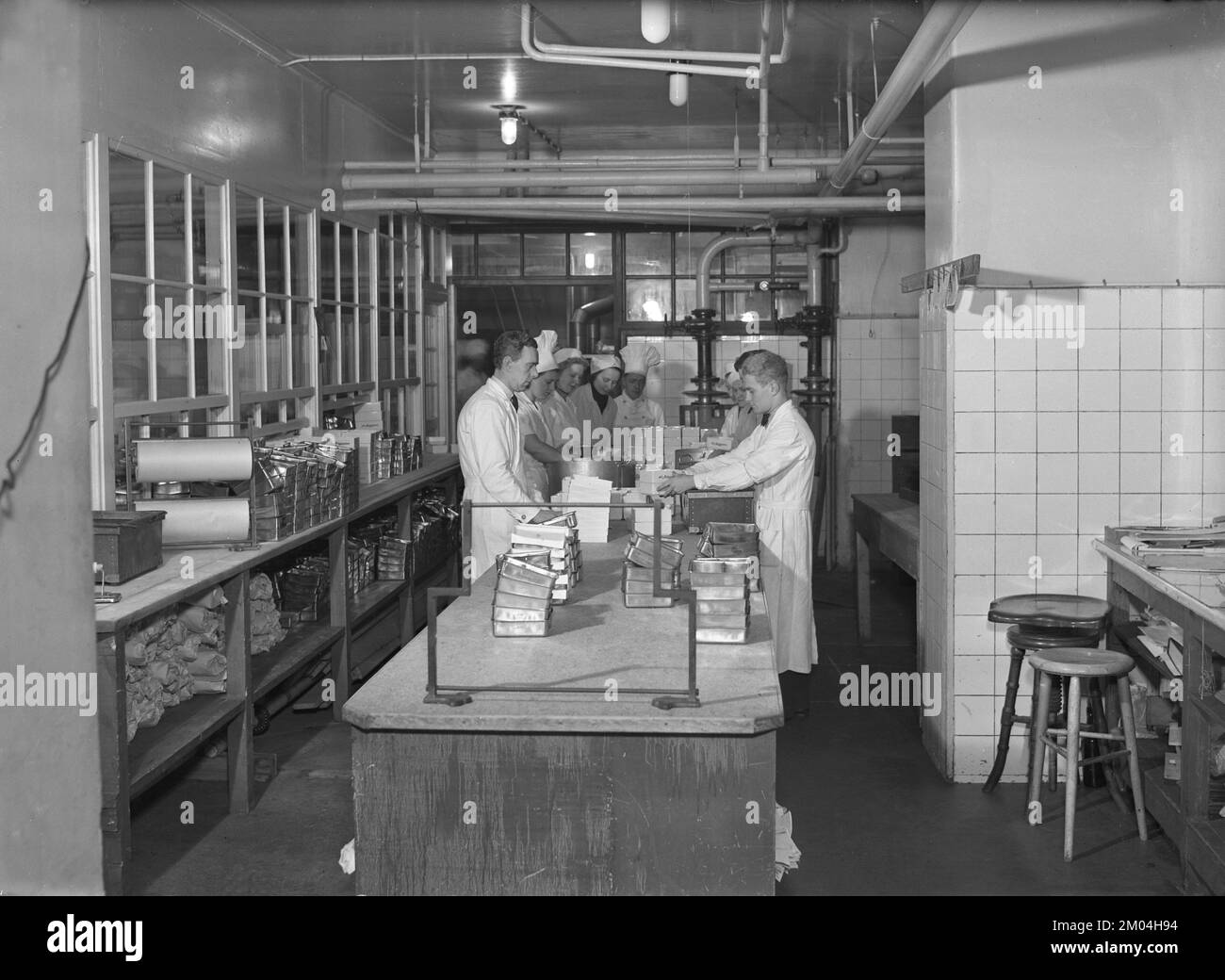 In the 1930s. The company Matexpressen and it's kitchen where they produce ready to eat dishes delivered by their messangers to the customers home. Not unlike today's service of food delivery and takeaway companys like Uber eats, Deliveroo, Just eat. This company had bad timing in starting their business with the second world war breaking out and was out of business in the middle of the 1940s. Sweden november 1939 Kristoffersson ref 11-9 Stock Photo