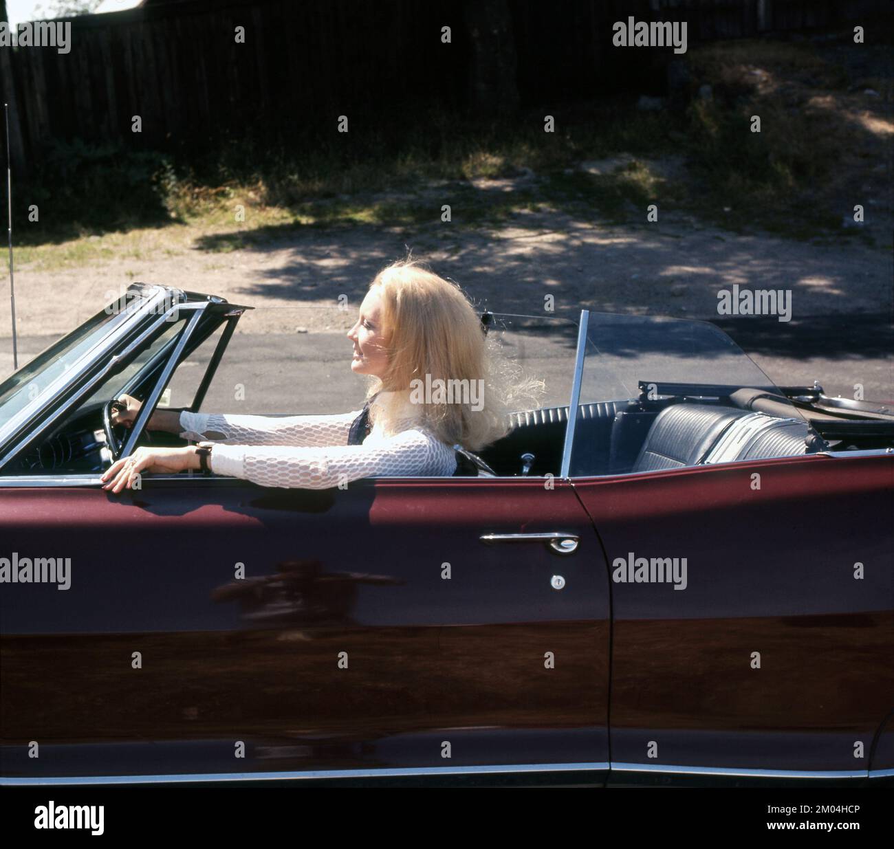 In the 1960s. A blonde young woman in the drivers seat of a convertible automobile. Sweden 1960s Stock Photo