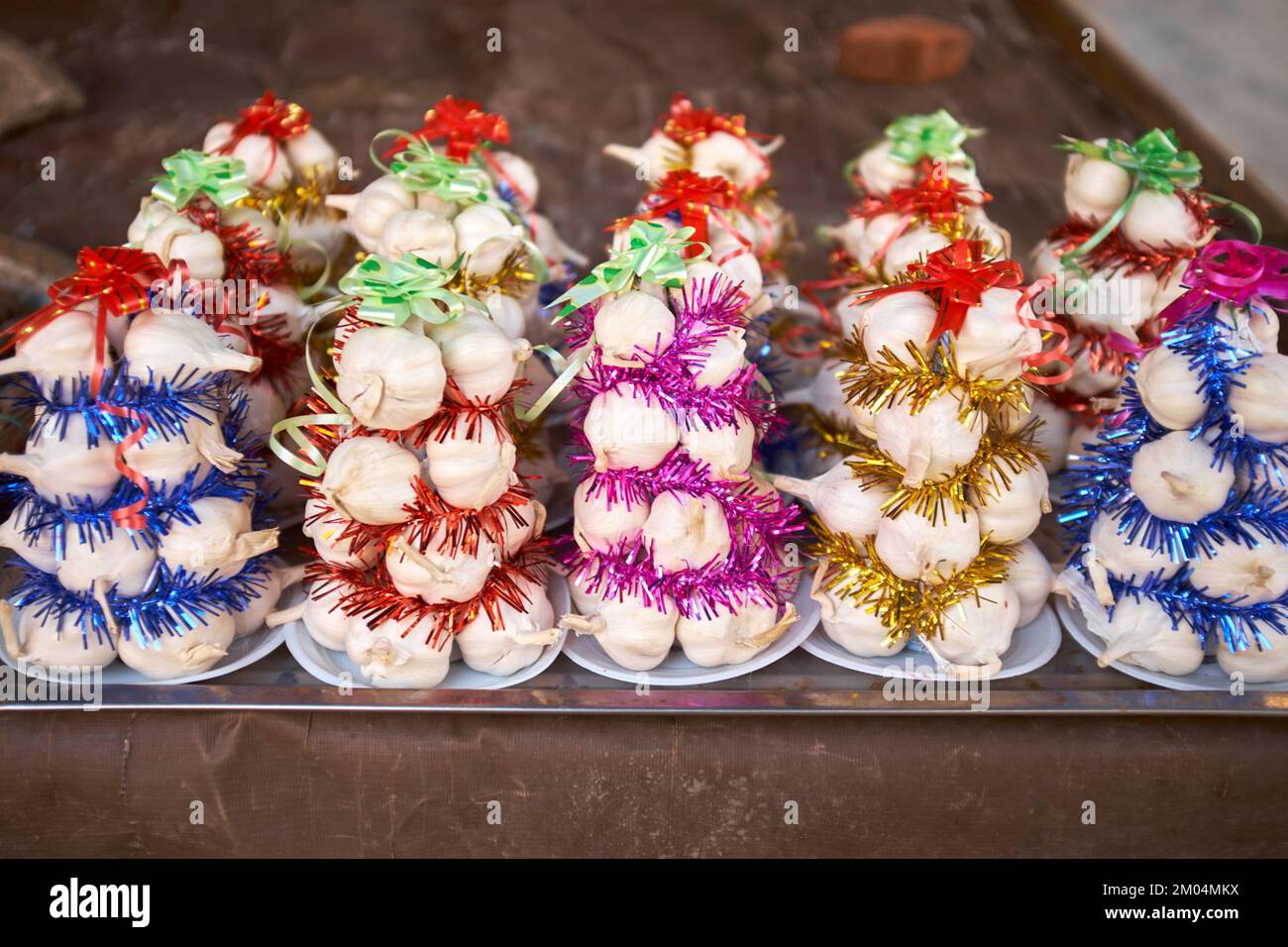 Garlic christmas trees on sale at the morning food market in Hoi An Vietnam Stock Photo