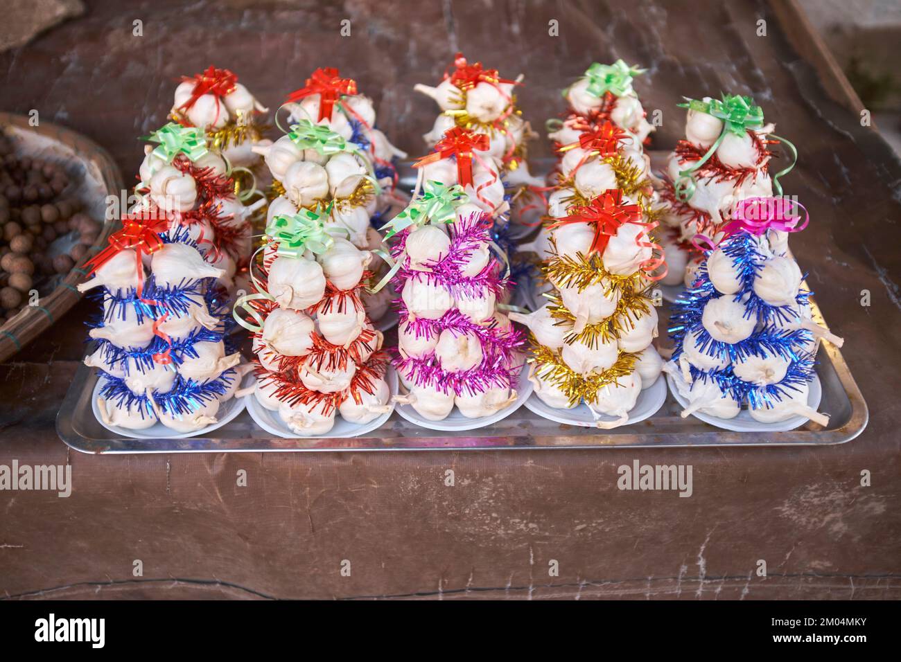 Garlic christmas trees on sale at the morning food market in Hoi An Vietnam Stock Photo