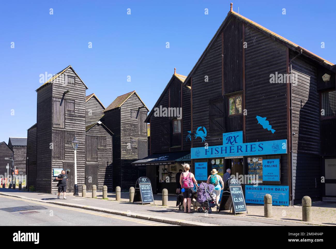 Hastings Old Town Fisheries on The Stade with traditional black painted tall net huts Hasting's Net Shops Hastings East Sussex England UK GB Europe Stock Photo