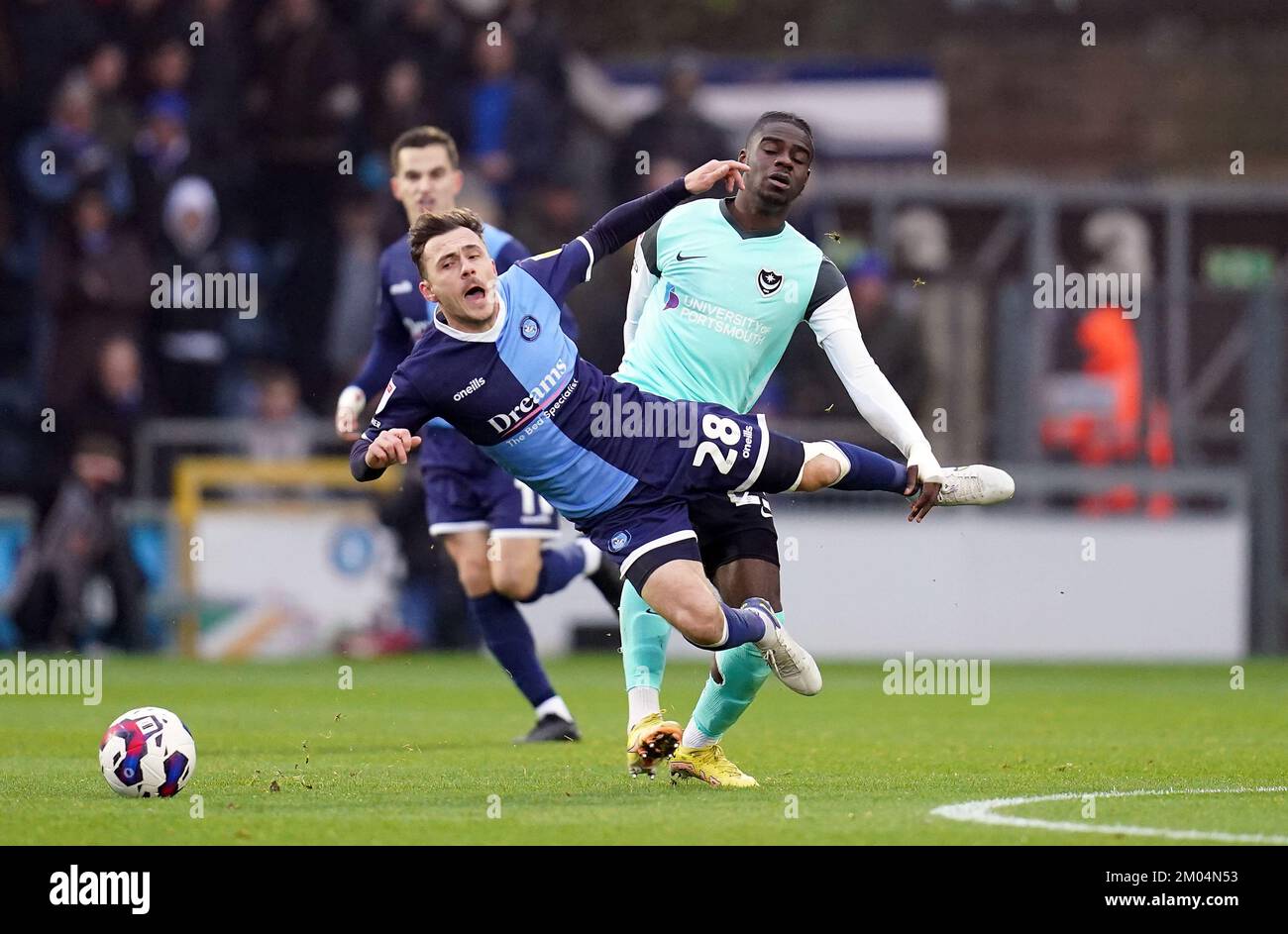 Wycombe Wanderers’ Josh Scowen is fouled by Portsmouth’s Jay Mingi during the Sky Bet League One match at Adams Park, Wycombe. Picture date: Sunday December 4, 2022. Stock Photo