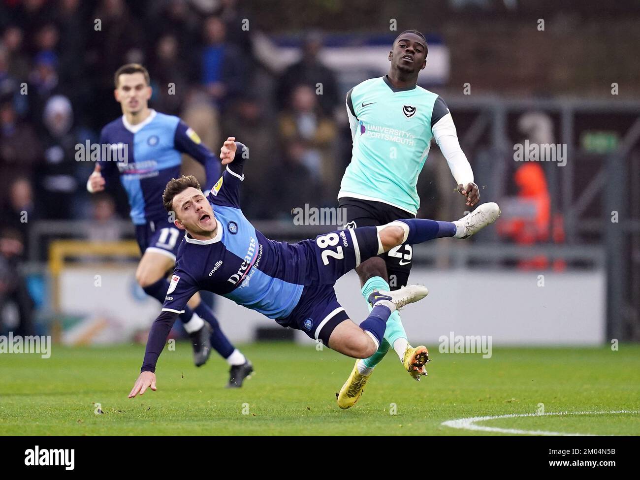 Wycombe Wanderers’ Josh Scowen is fouled by Portsmouth’s Jay Mingi during the Sky Bet League One match at Adams Park, Wycombe. Picture date: Sunday December 4, 2022. Stock Photo