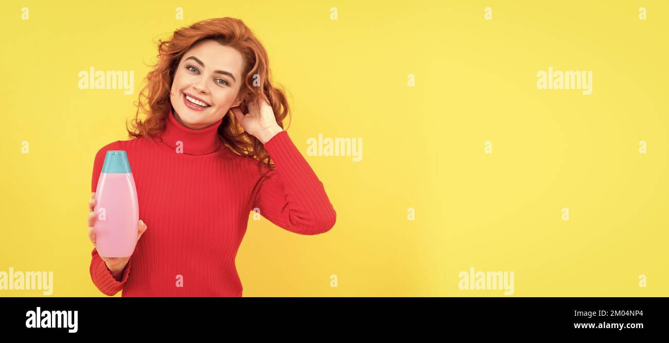 happy woman use shower gel. positive girl curly hair hold shampoo