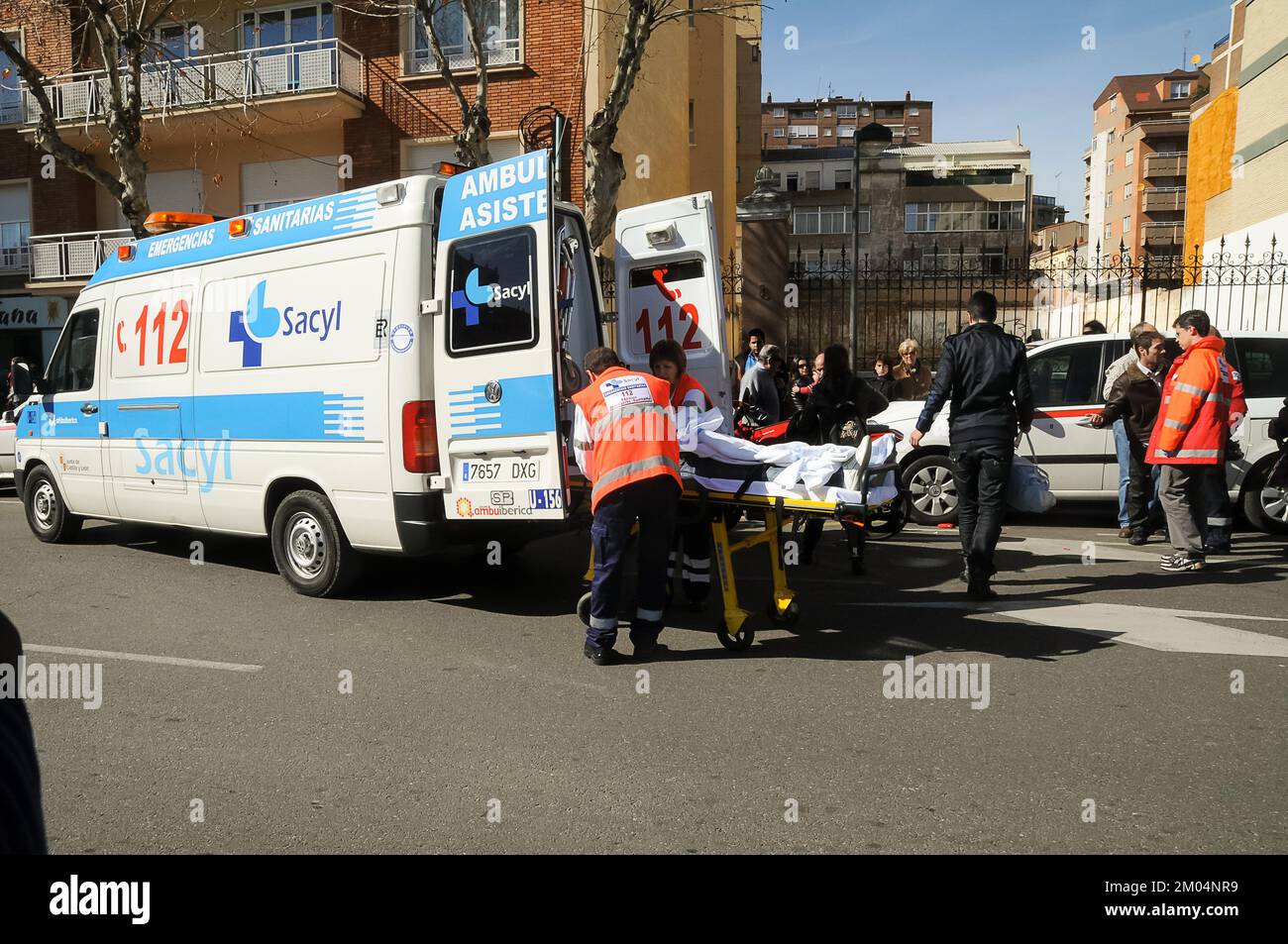 Ambulance being loaded with an injured person from a traffic accident on a city road. Stock Photo