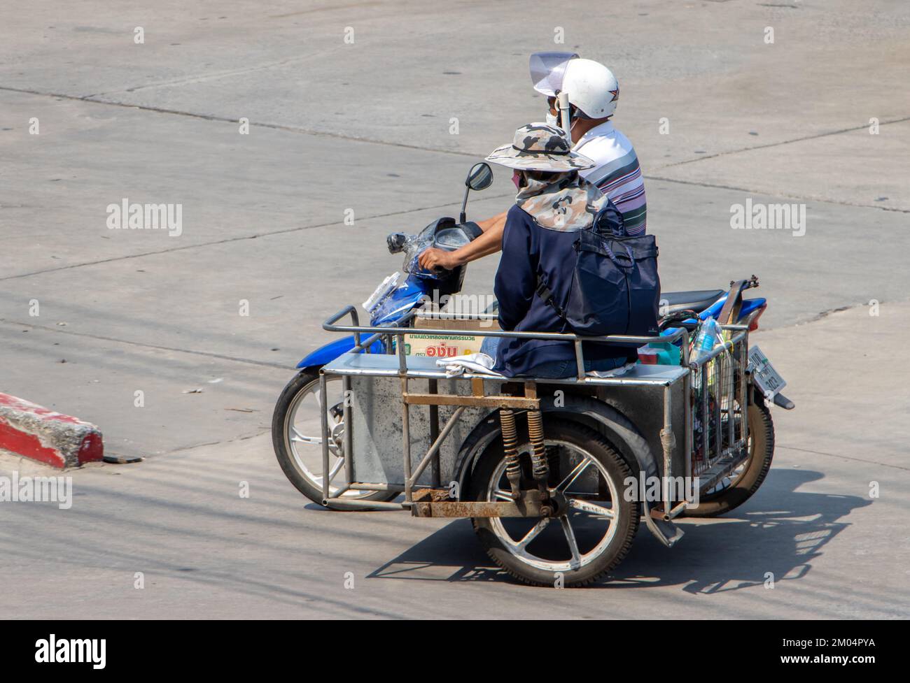 SAMUT PRAKAN, THAILAND, MARCH 02 2022, A couple is riding a motorcycle with a sidecar Stock Photo