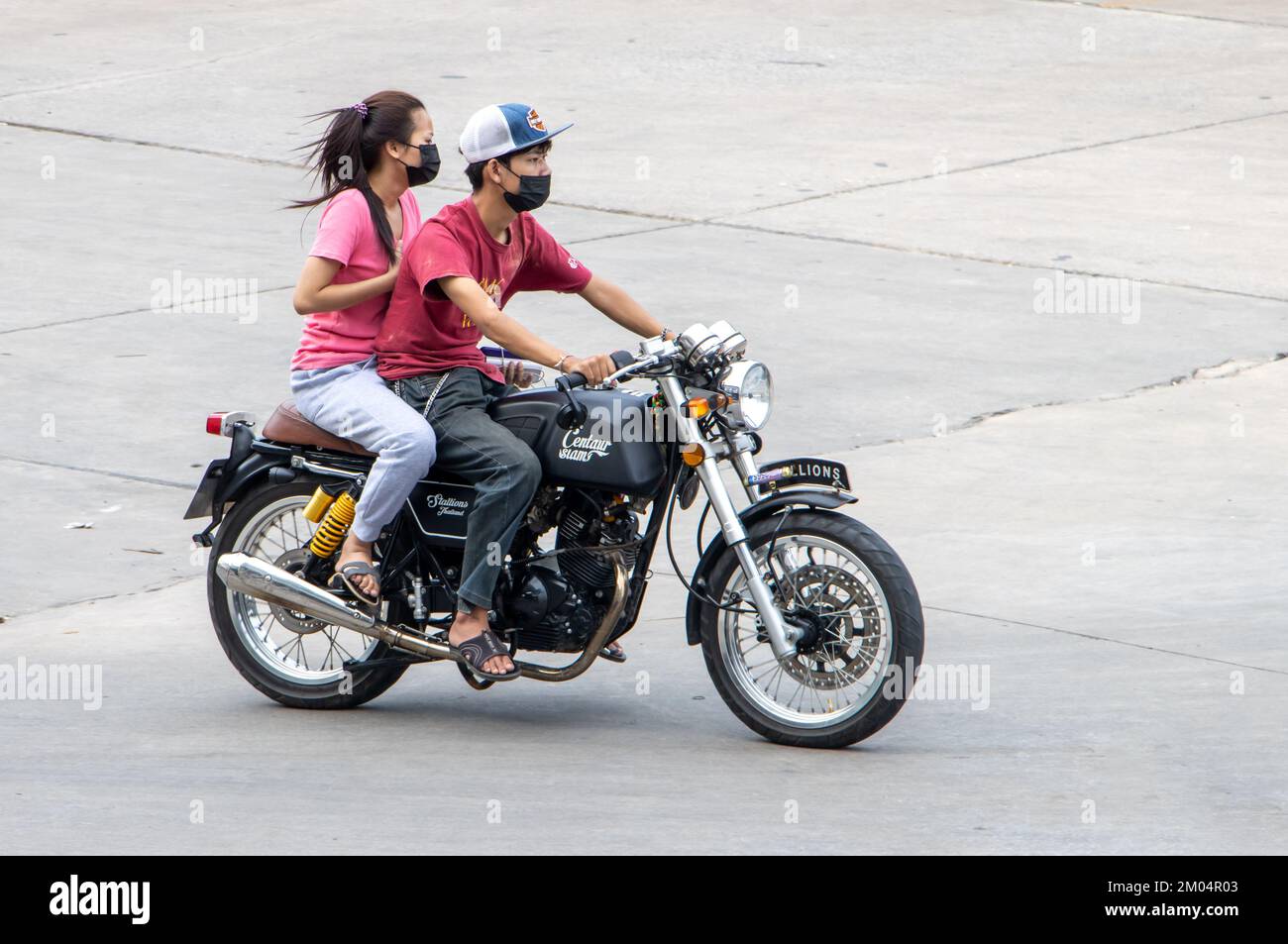 SAMUT PRAKAN, THAILAND, MARCH 02 2022, The pair rides on motorcycle at the street. Stock Photo