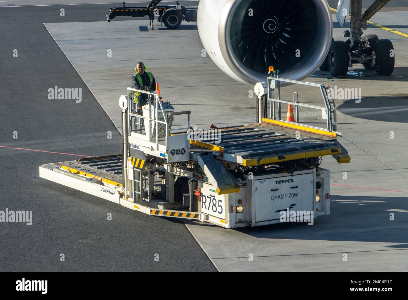An empty vehicle - cargo high loader rides on a runway, Helsinki, Finland Stock Photo