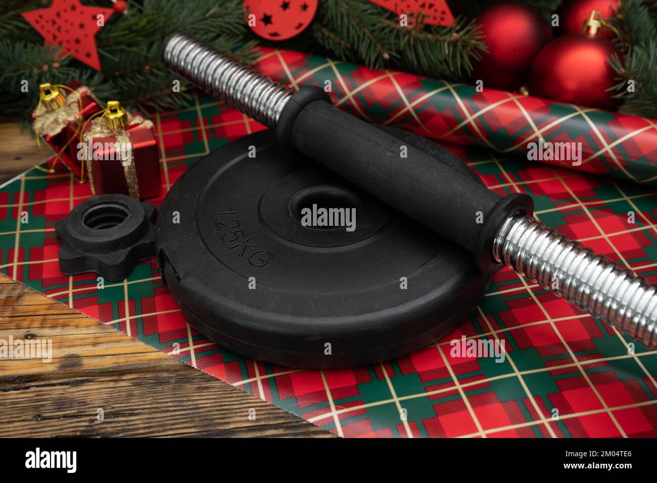 Gym dumbbell weight plate disc on wrapping paper. Exercise equipment as
