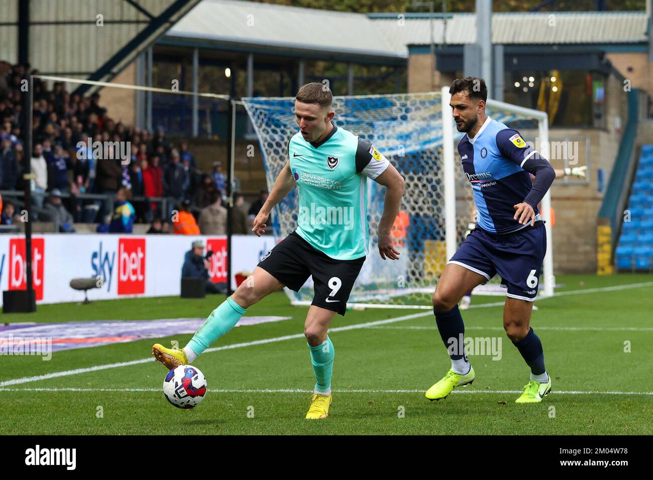 Colby Bishop of Portsmouth FC is pressured by Ryan Tafazolli of Wycombe Wanderers during the Sky Bet League 1 match Wycombe Wanderers vs Portsmouth at Adams Park, High Wycombe, United Kingdom, 4th December 2022  (Photo by Nick Browning/News Images) Stock Photo