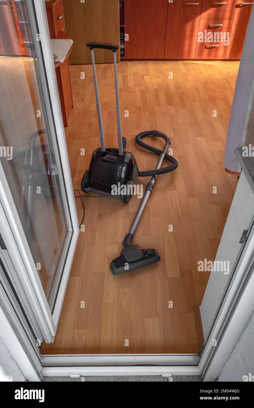 Room vacuum cleaner on the floor of the living room. View from the
