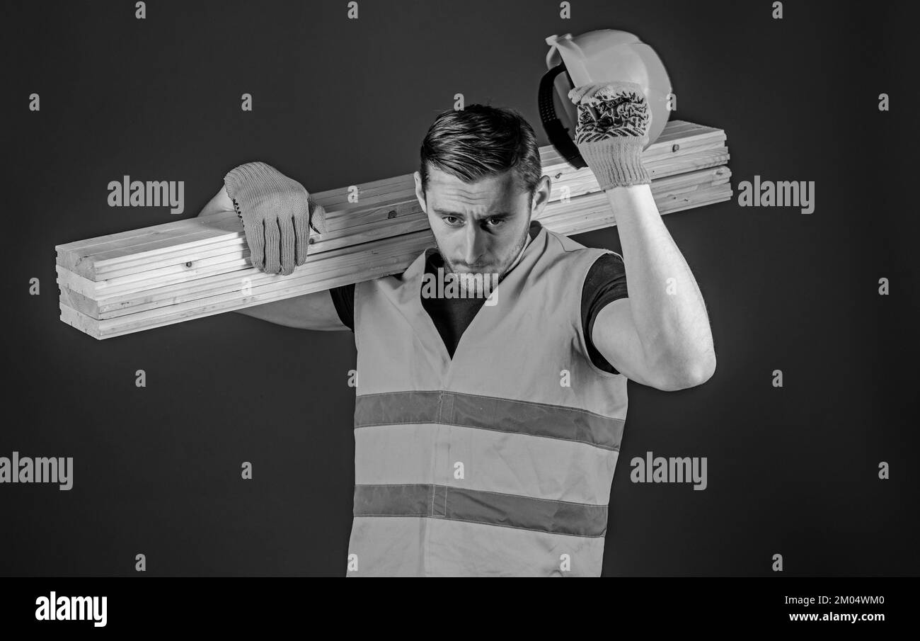 Protective equipment concept. Man in protective gloves holds visor of helmet, corrects hard hat