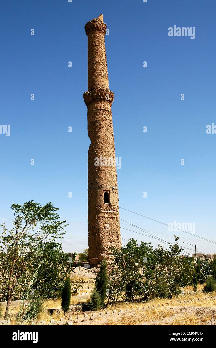 Herat in Afghanistan. One of the Musalla Minarets of Herat part of the Musalla Complex. This minaret is leaning at a precarious angle, held by cables. Stock Photo