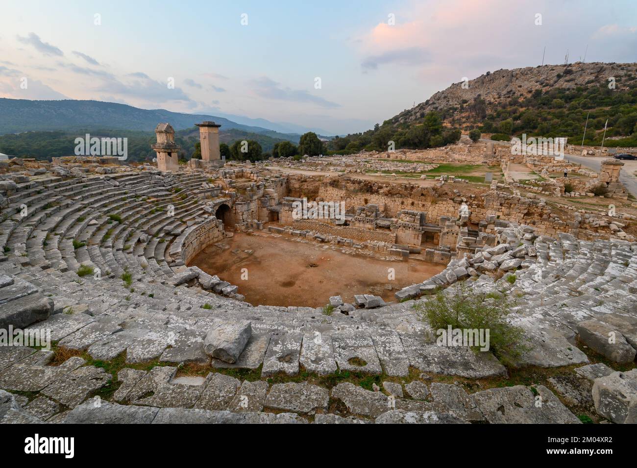 Xanthos Ancient City. Grave monument and the ruins of ancient city of Xanthos - Letoon in Kas, Antalya, Turkey at sunset. Capital of Lycia. Stock Photo