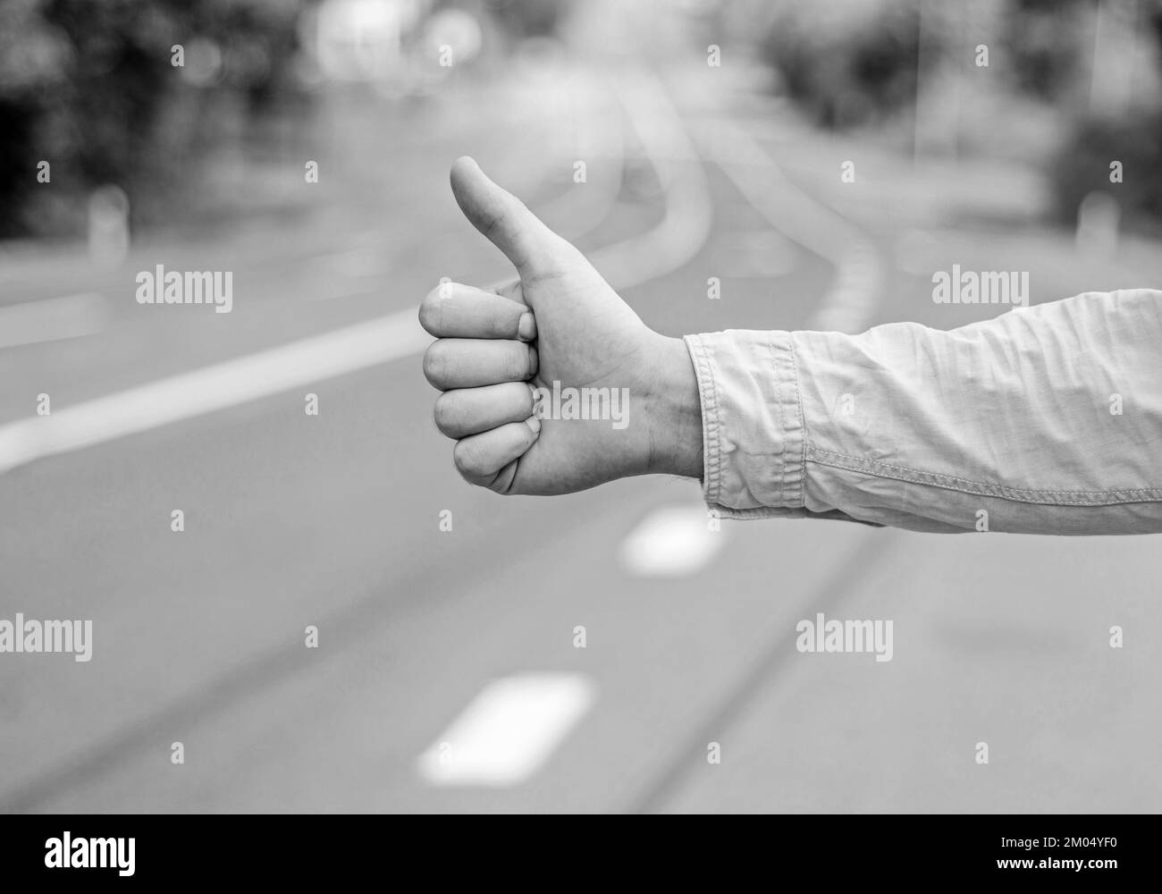 Thumb up gesture try stop car road background. Hand gesture hitchhiking
