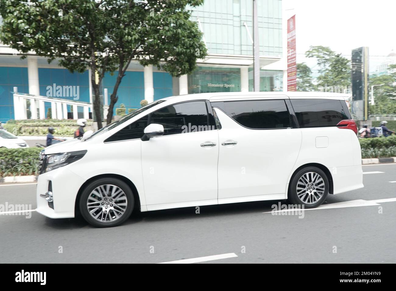 Luxury car Toyota Alphard on the street, in comercial district area