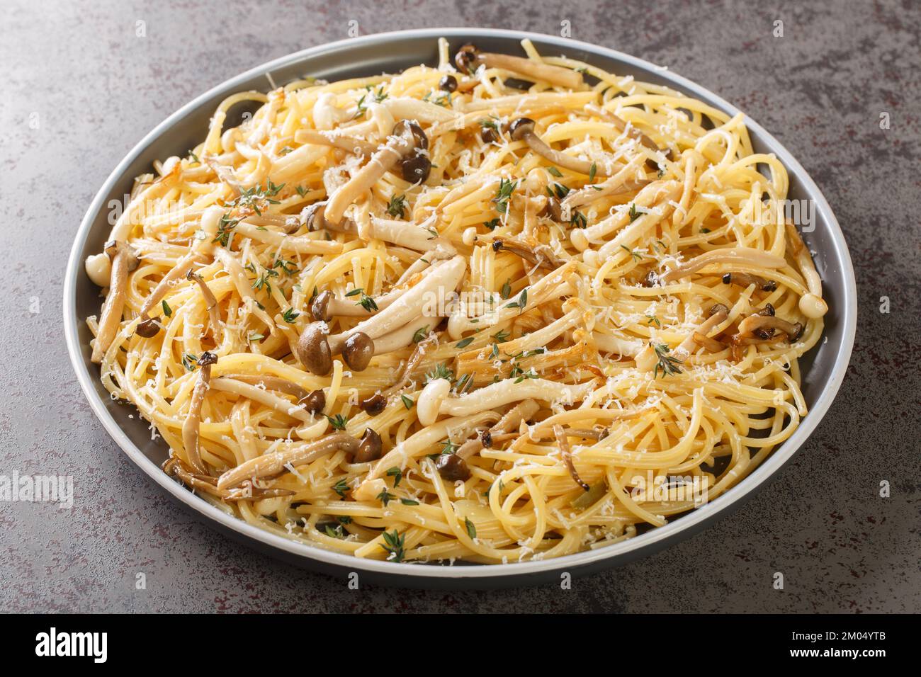Spaghetti pasta with fried shimeji beech mushrooms with parmesan and