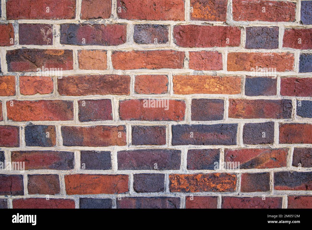 Old red and orange brick wall background texture close-up. Stock Photo