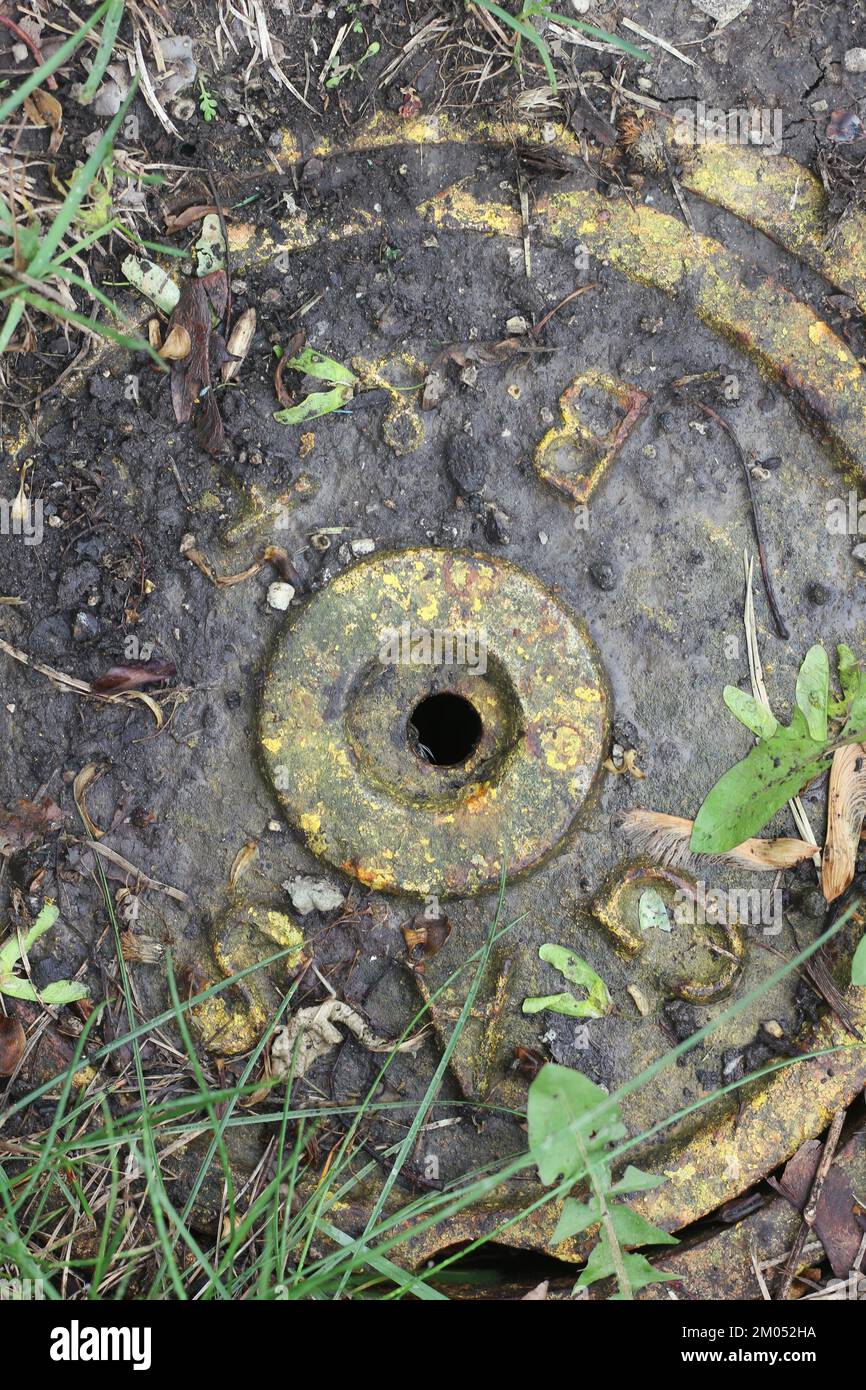 Vintage traditional metal drain cover with safety yellow paint Stock