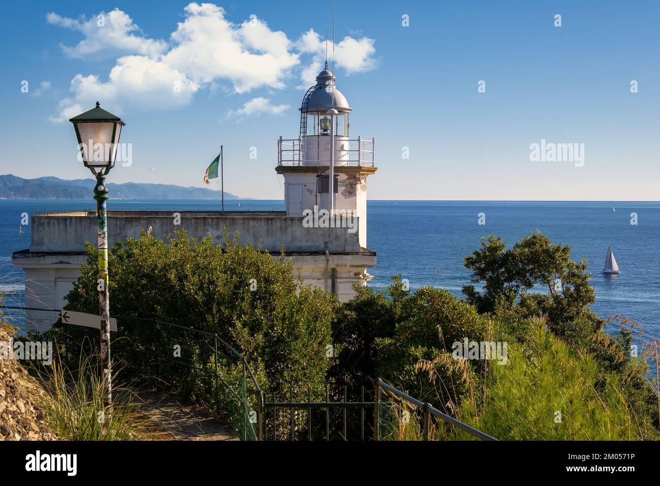 Portofino Lighthouse overlooking the water with white clouds, Liguria, Italy Stock Photo