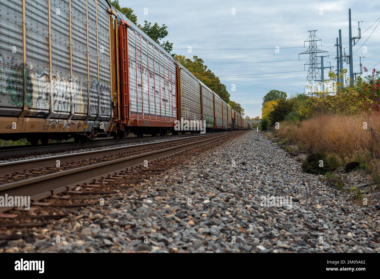 Freight train travelling through rural area in the midwest Stock Photo