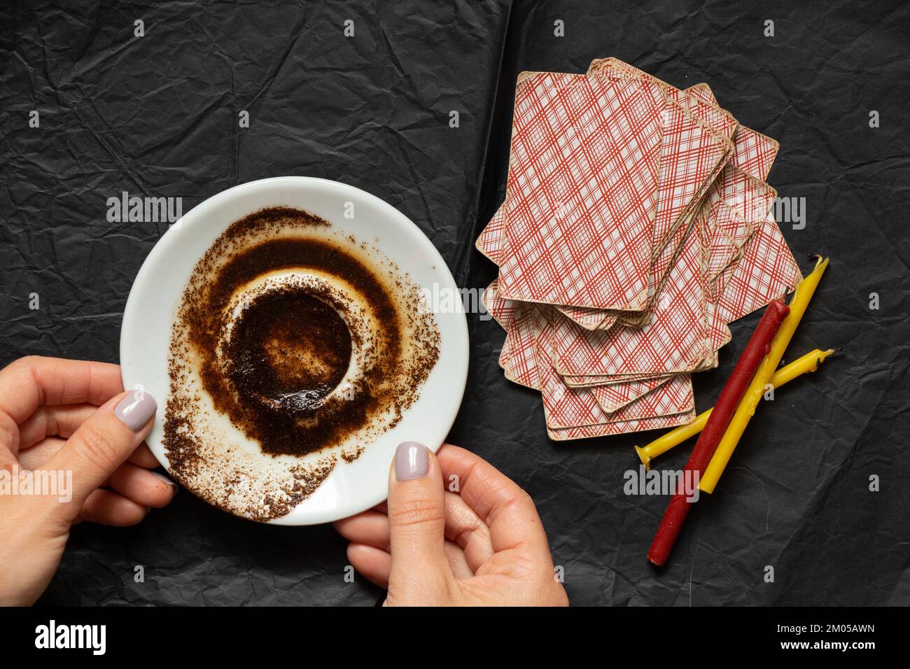 coffee grounds in the hands of a fortune teller and cards and candles