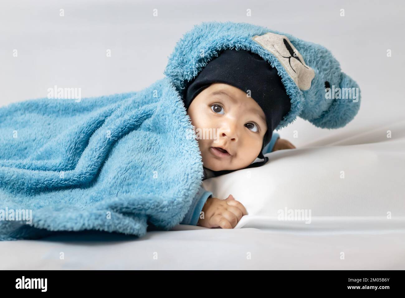 infant boy lying cute facial expression with white background at indoor Stock Photo